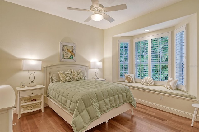 bedroom with ceiling fan and wood-type flooring