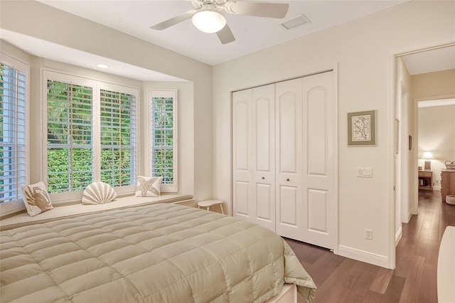 bedroom with a closet, ceiling fan, and dark hardwood / wood-style floors