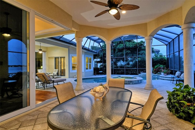 view of patio / terrace with ceiling fan, a pool with hot tub, and a lanai