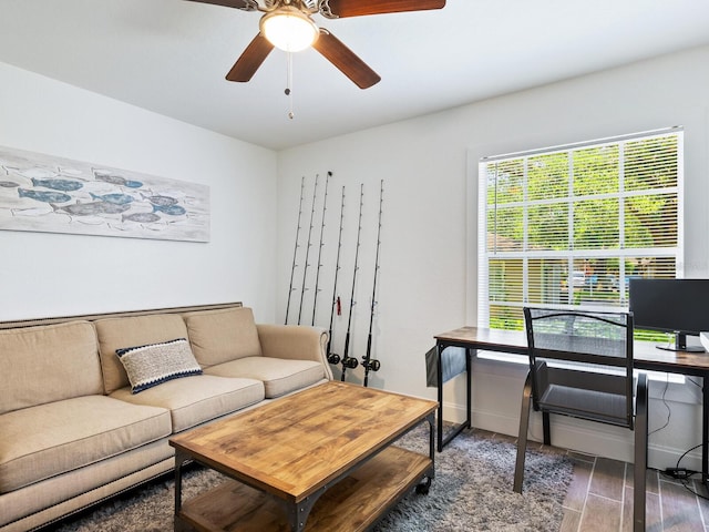 living room featuring dark hardwood / wood-style floors and ceiling fan