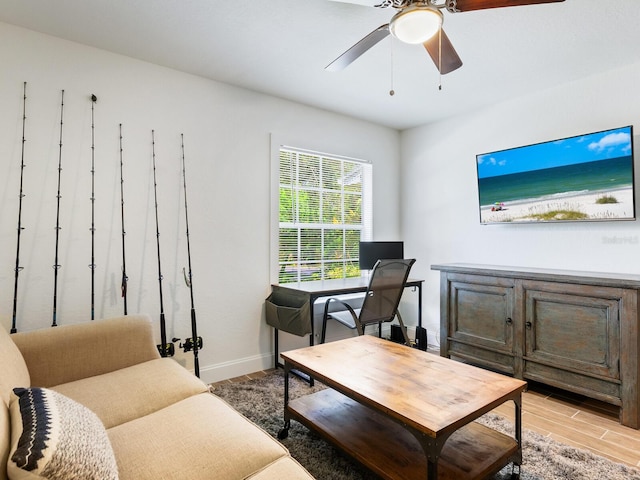 living room featuring ceiling fan and light wood-type flooring