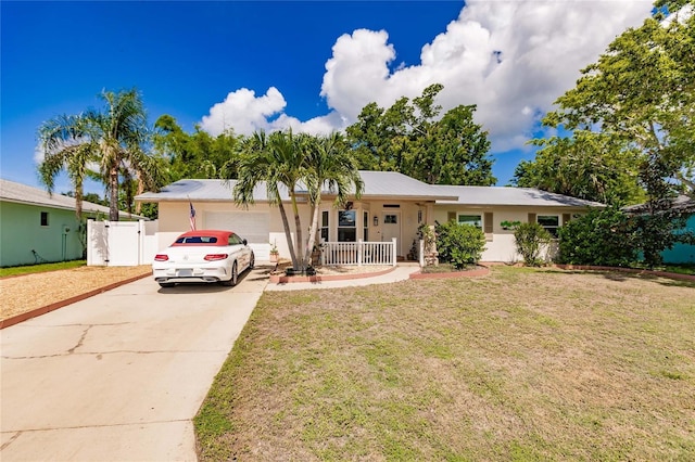 ranch-style house with a garage, covered porch, and a front lawn