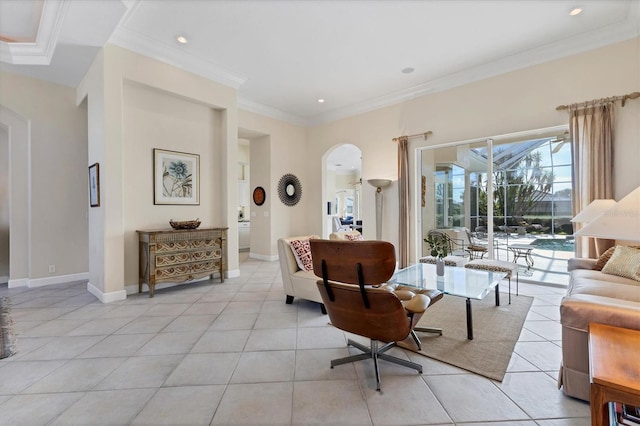 living room with light tile patterned floors, baseboards, arched walkways, and ornamental molding