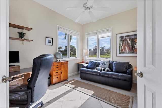 office featuring baseboards, a ceiling fan, and light tile patterned flooring