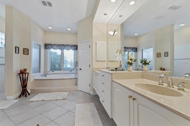 bathroom featuring tile patterned flooring, visible vents, vanity, and a bath