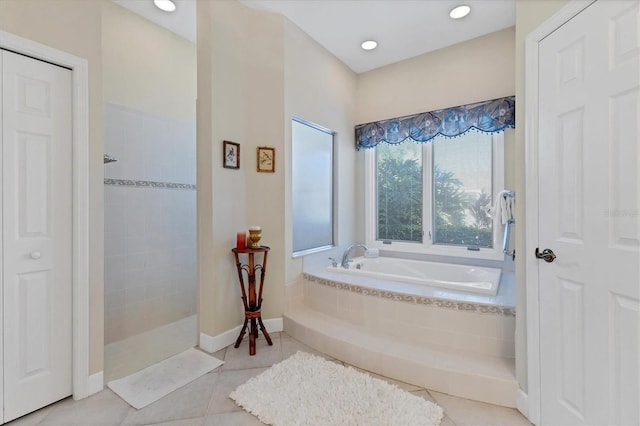 bathroom with tile patterned flooring, a closet, a bath, and a walk in shower