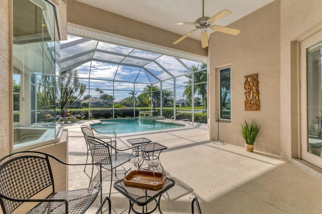 view of patio / terrace featuring a lanai and a pool with connected hot tub