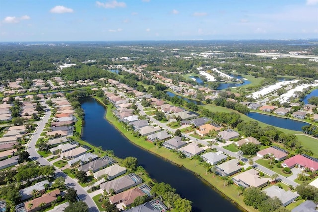 birds eye view of property with a water view and a residential view