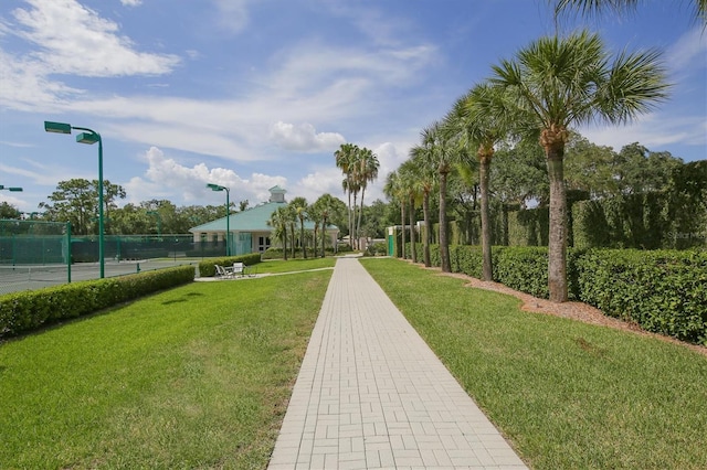 view of home's community featuring a yard and fence