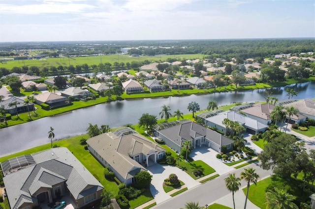 drone / aerial view with a water view and a residential view