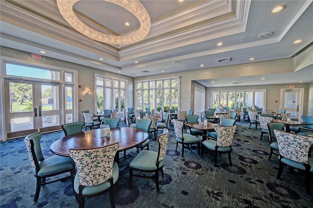 dining room with a tray ceiling, french doors, visible vents, and crown molding