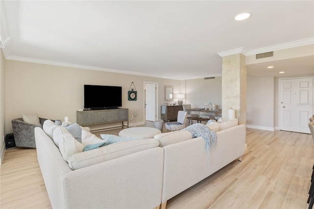 living room with crown molding and light hardwood / wood-style floors