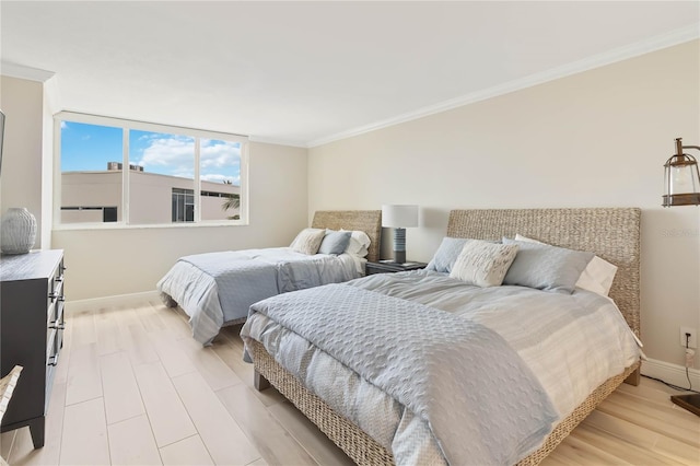 bedroom featuring light wood-type flooring and ornamental molding