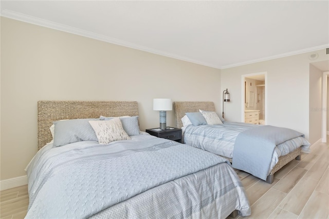 bedroom featuring ensuite bathroom and crown molding