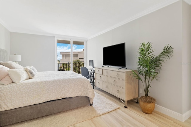 bedroom with access to outside, expansive windows, crown molding, and hardwood / wood-style flooring