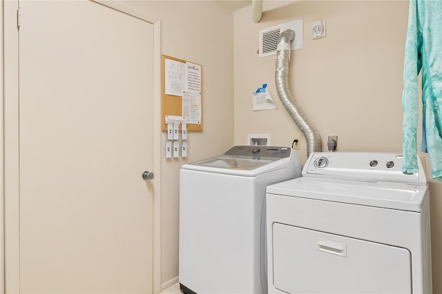 laundry room featuring washing machine and clothes dryer