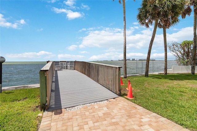 view of home's community featuring a water view and a lawn