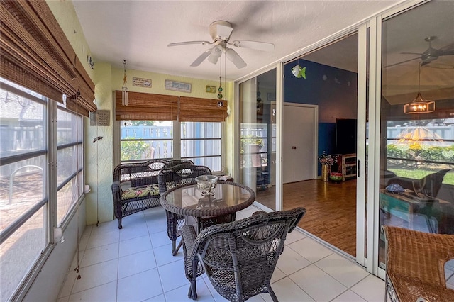 sunroom with a ceiling fan