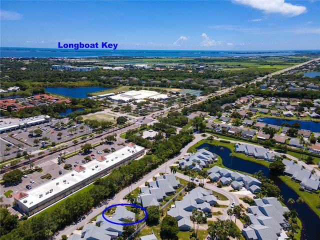 drone / aerial view with a residential view and a water view