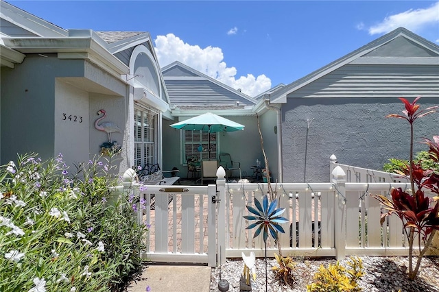 view of home's exterior featuring a fenced front yard and stucco siding