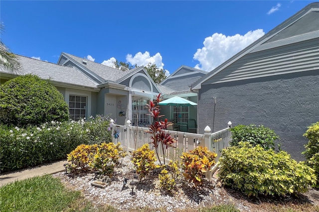 exterior space with fence and stucco siding