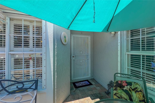 property entrance featuring stucco siding