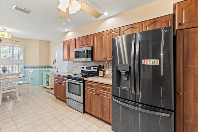 kitchen with stainless steel appliances, visible vents, light countertops, decorative backsplash, and brown cabinets