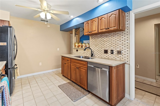 kitchen featuring sink, backsplash, light tile patterned floors, ceiling fan, and stainless steel appliances