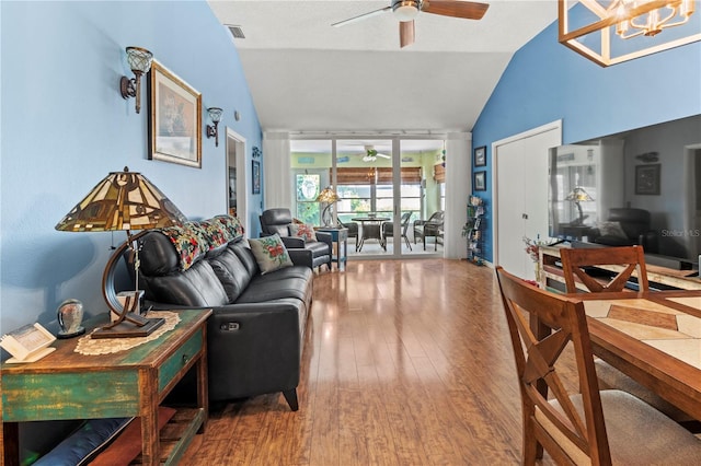 living room featuring vaulted ceiling, ceiling fan, and hardwood / wood-style floors