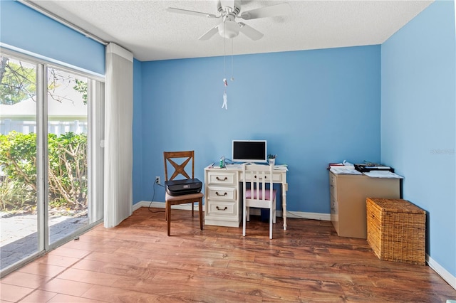 office area with hardwood / wood-style flooring, ceiling fan, a healthy amount of sunlight, and a textured ceiling