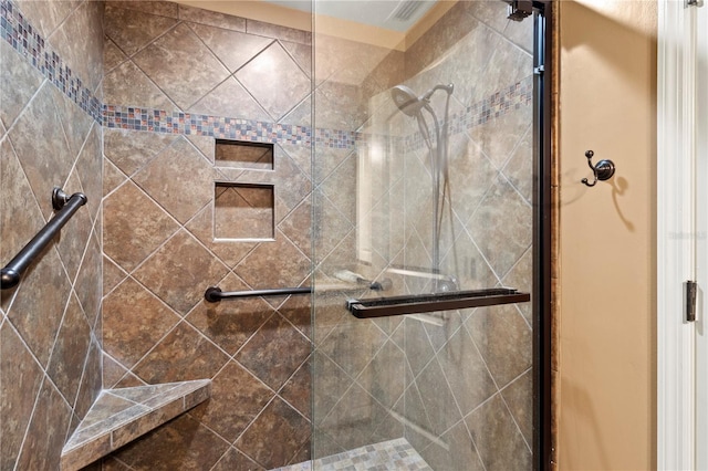 bathroom featuring a shower with shower door