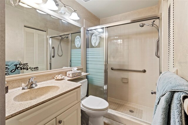 bathroom with vanity, walk in shower, and toilet