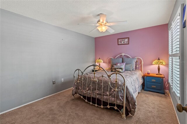 carpeted bedroom featuring ceiling fan and a textured ceiling