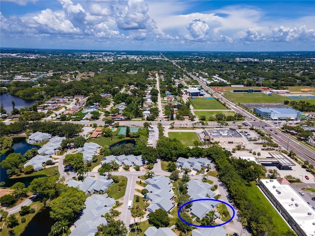 drone / aerial view with a water view and a residential view