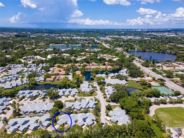 drone / aerial view with a water view and a residential view