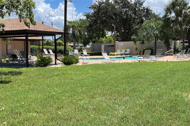 view of yard with a gazebo, a community pool, and a patio area