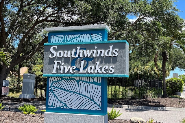 community / neighborhood sign with fence