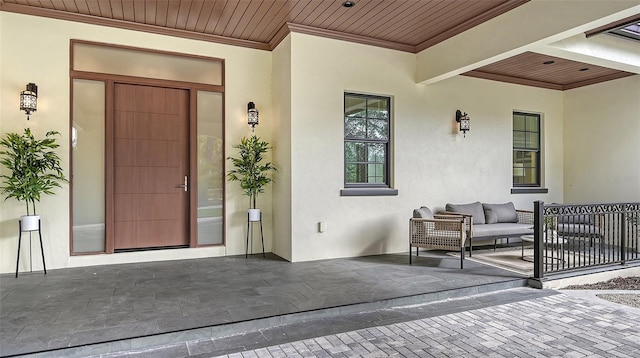 entrance to property with an outdoor hangout area and a patio area