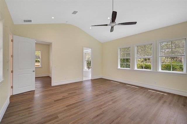 unfurnished room with ceiling fan, plenty of natural light, and wood-type flooring