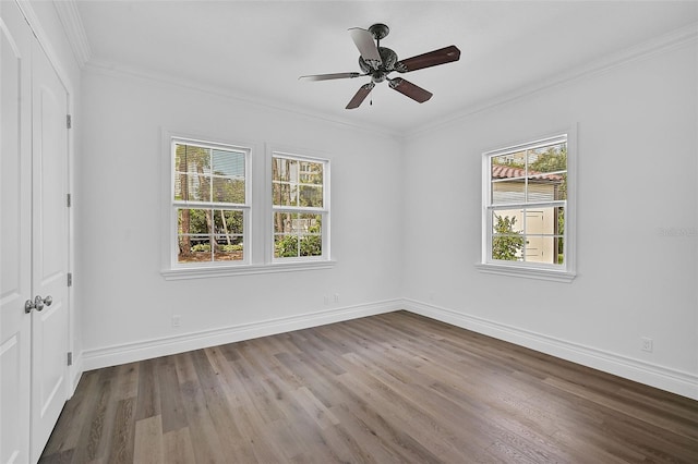 empty room with ceiling fan, ornamental molding, and hardwood / wood-style floors