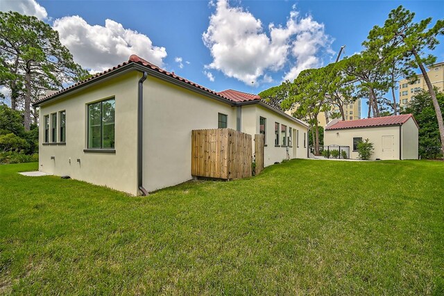 exterior space featuring an outbuilding and a lawn