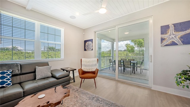 living room featuring light wood-type flooring, ceiling fan, and wooden ceiling