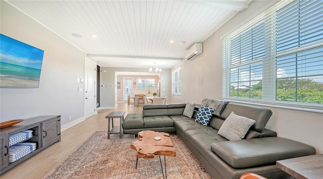 living room with beamed ceiling, a wall mounted AC, and light wood-type flooring