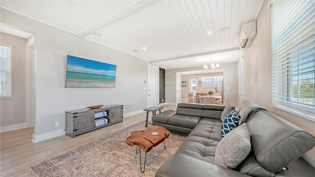 living room featuring an AC wall unit, beamed ceiling, light wood-type flooring, and a notable chandelier