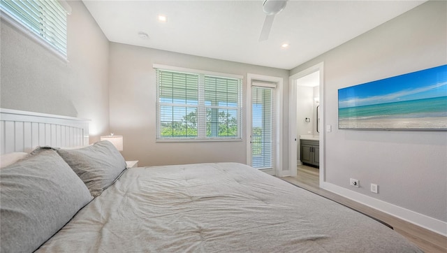 bedroom featuring connected bathroom, light hardwood / wood-style flooring, and ceiling fan