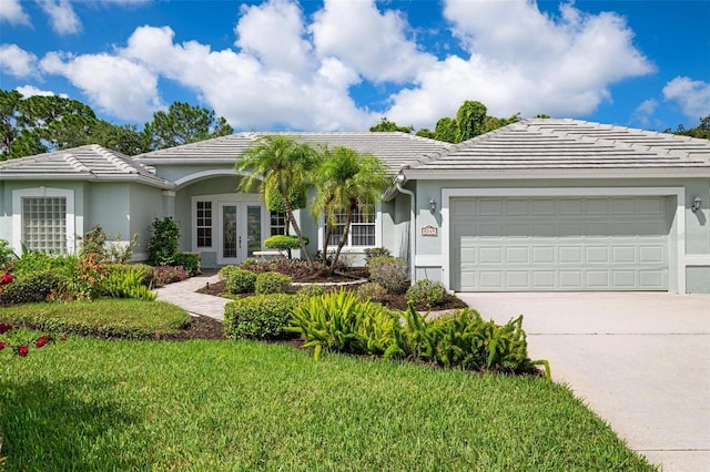 ranch-style house featuring a garage and a front yard