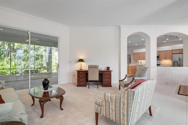 living room featuring ceiling fan, light tile patterned floors, and ornamental molding