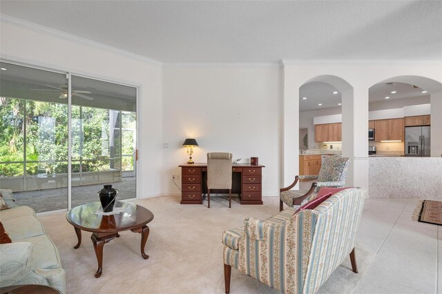 5249 Far Oak Cir, Sarasota, FL 34238 - living area with crown molding, ceiling fan, an office area, and arched walkways