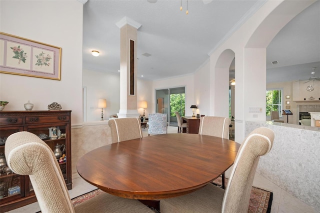 5249 Far Oak Cir, Sarasota, FL 34238 - tiled dining space with arched walkways, a ceiling fan, and ornamental molding