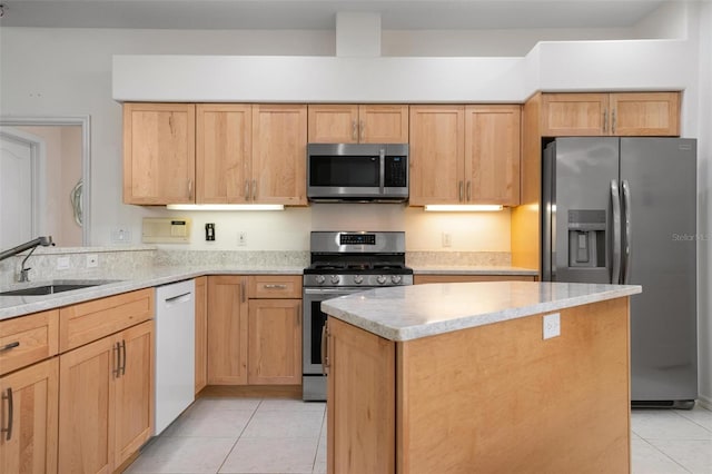5249 Far Oak Cir, Sarasota, FL 34238 - kitchen with stainless steel appliances, a sink, light tile patterned floors, a kitchen island, and light stone countertops